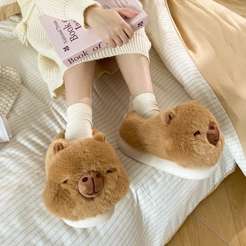 Light brown women's winter plush slippers with a cartoon pattern, round toe, and a pull-on oversleeve design.