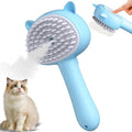 Blue cat steam brush with ergonomic handle, soft rubber teeth, and release button for pet grooming