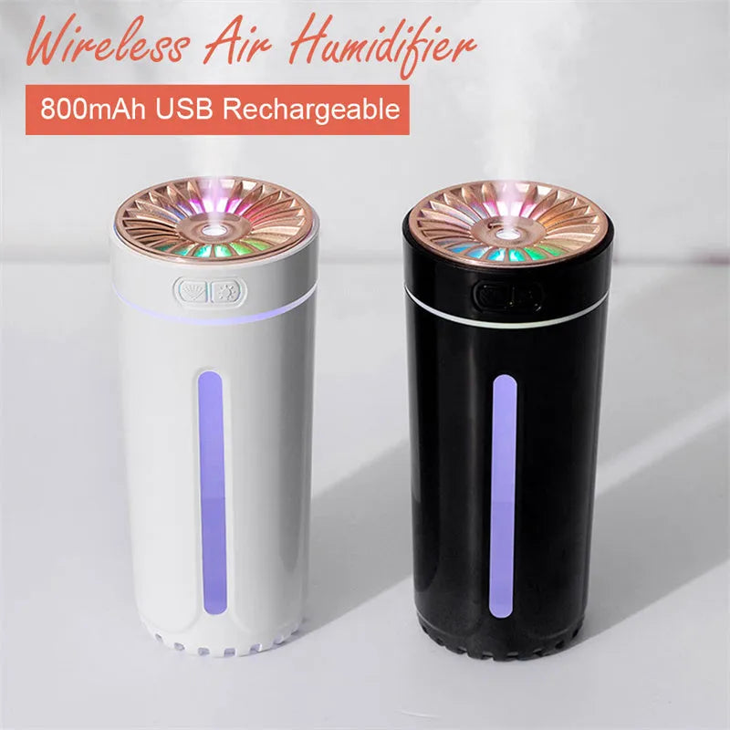 Black and white portable USB rechargeable humidifier with colourful LED lights on a car cup holder.