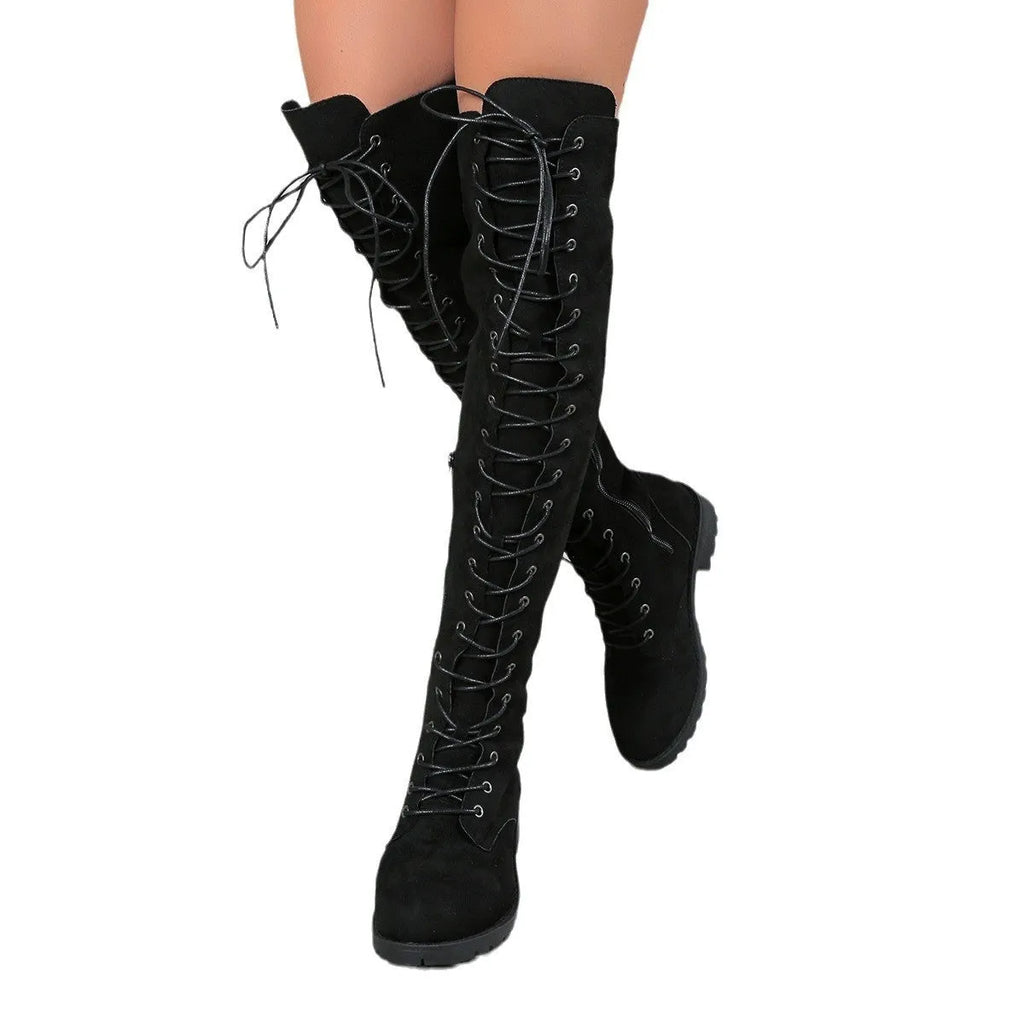 A pair of black lace-up over-the-knee boots with a round toe and flat rubber sole on a white background.