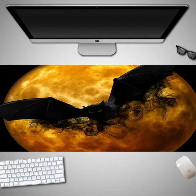 Oversized Halloween-themed gaming mouse pad with non-slip base on a desk.
