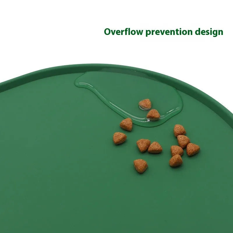 Green silicone cat feeding placemat with a food bowl on it, showing its waterproof, wipe-clean surface.