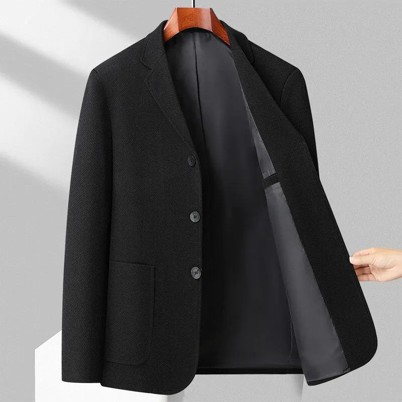 A man wearing a solid colour loose-fit wool blend coat suitable for spring or autumn.