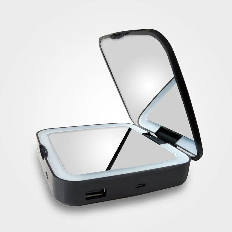Black and white makeup mirror with LED lights around the edge, showing both the magnifying and standard mirror sides.