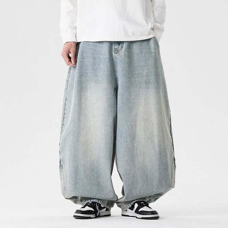 Men's loose-fit straight leg jeans in black denim on a hanger.