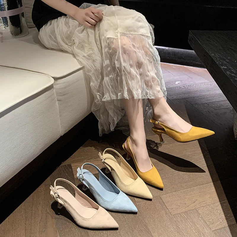 A pair of apricot suede pointed toe stiletto high heels with a rubber sole.