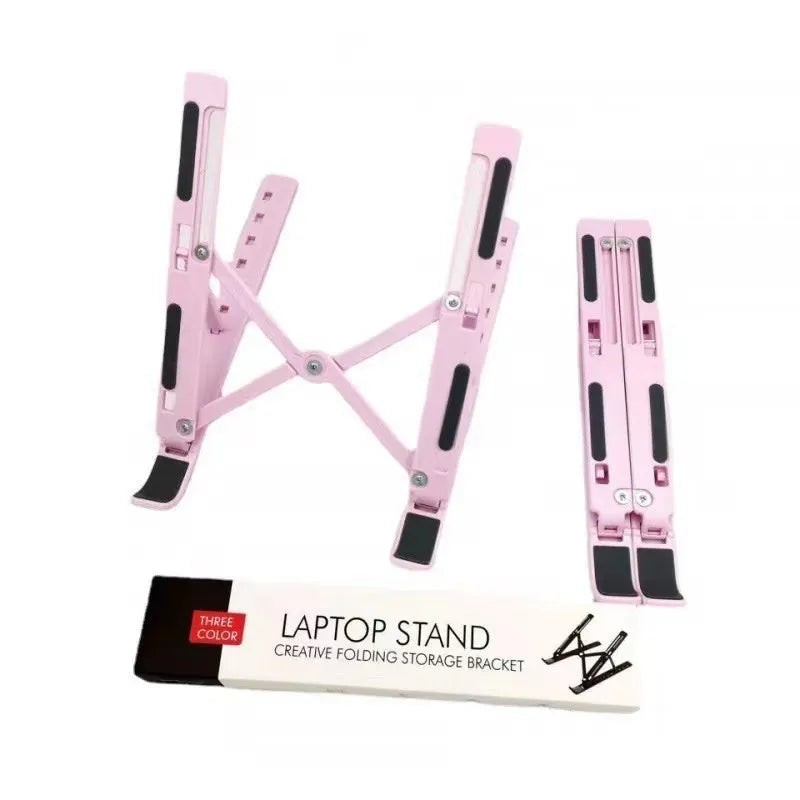 Silver aluminium alloy folding laptop stand with black silicone pads on a wooden desk.