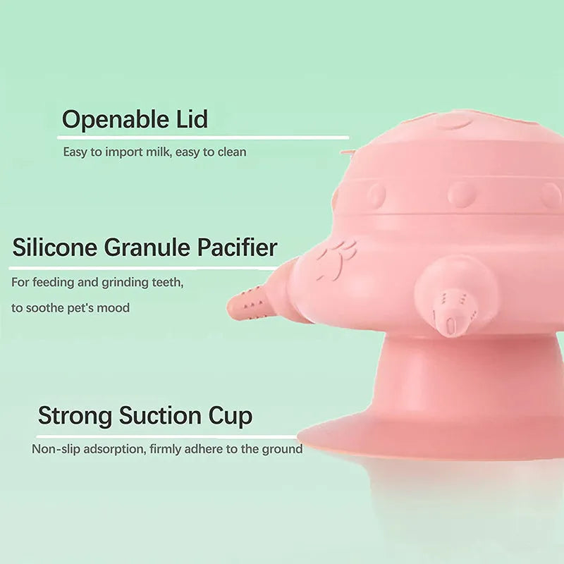 Pink silicone pet nursing milk feeder bowl with four pacifiers on a flat base.
