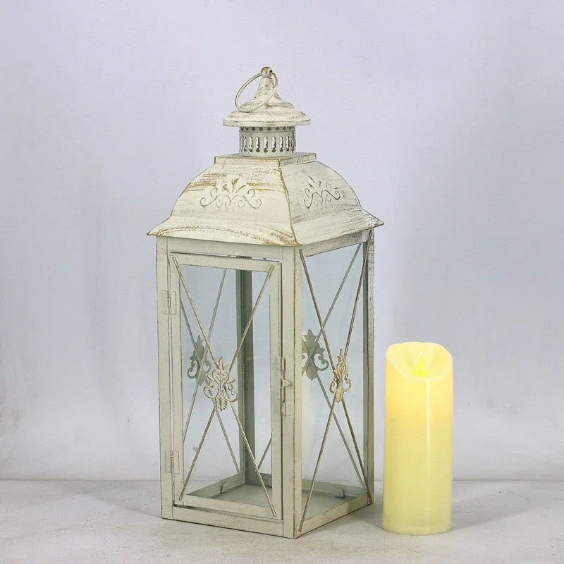 Black and white wrought iron floor-standing storm lantern with tempered glass in three sizes for courtyard use.