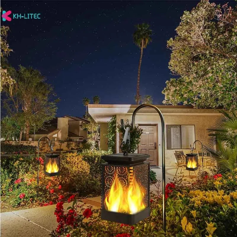 Set of four black solar-powered LED lanterns with flame flicker effect for outdoor garden use.