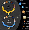 Set of two natural stone beaded bracelets showing zodiac sign designs on a dark background.