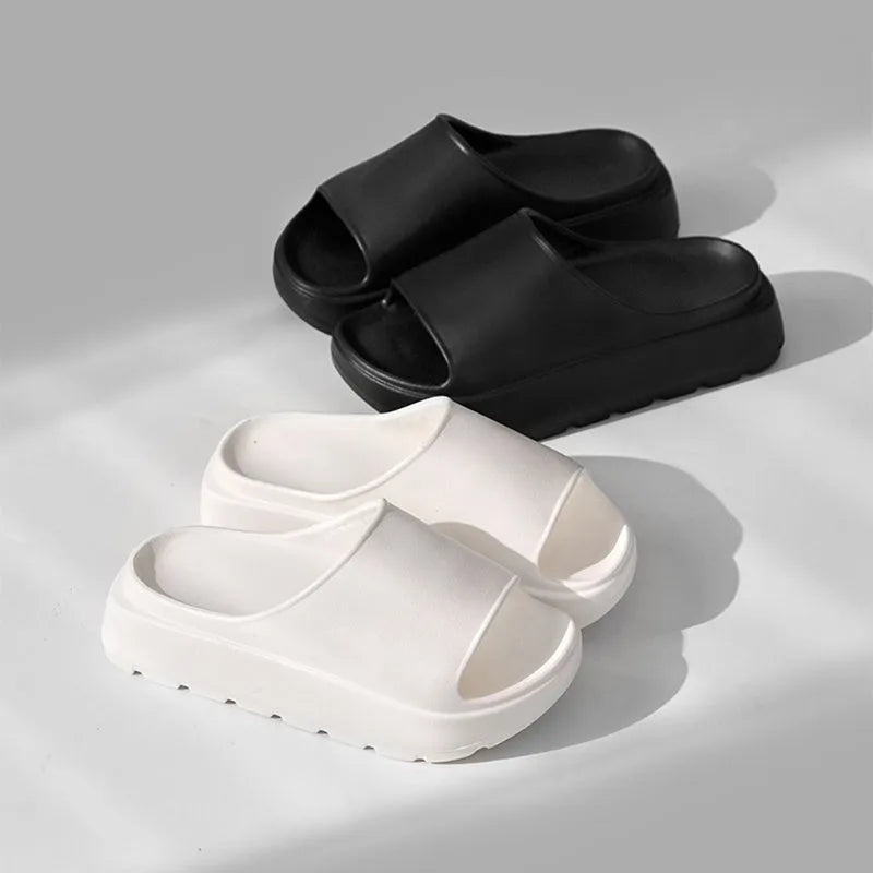 Women's beige fish mouth slippers with a thick 5.5cm EVA platform sole on a wooden floor.