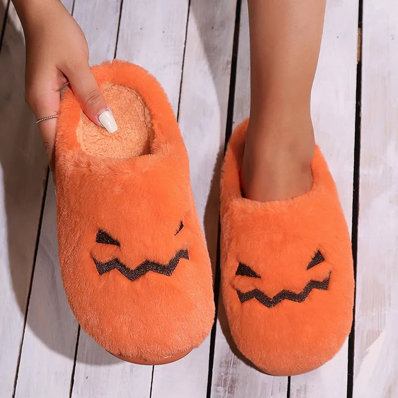Orange Halloween pumpkin slippers with coral velvet upper and plush lining.