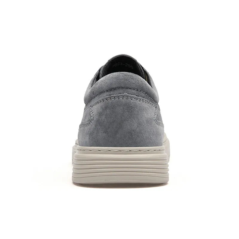Men's grey low-top casual skate shoes with pigskin upper and rubber sole, shown from the side.