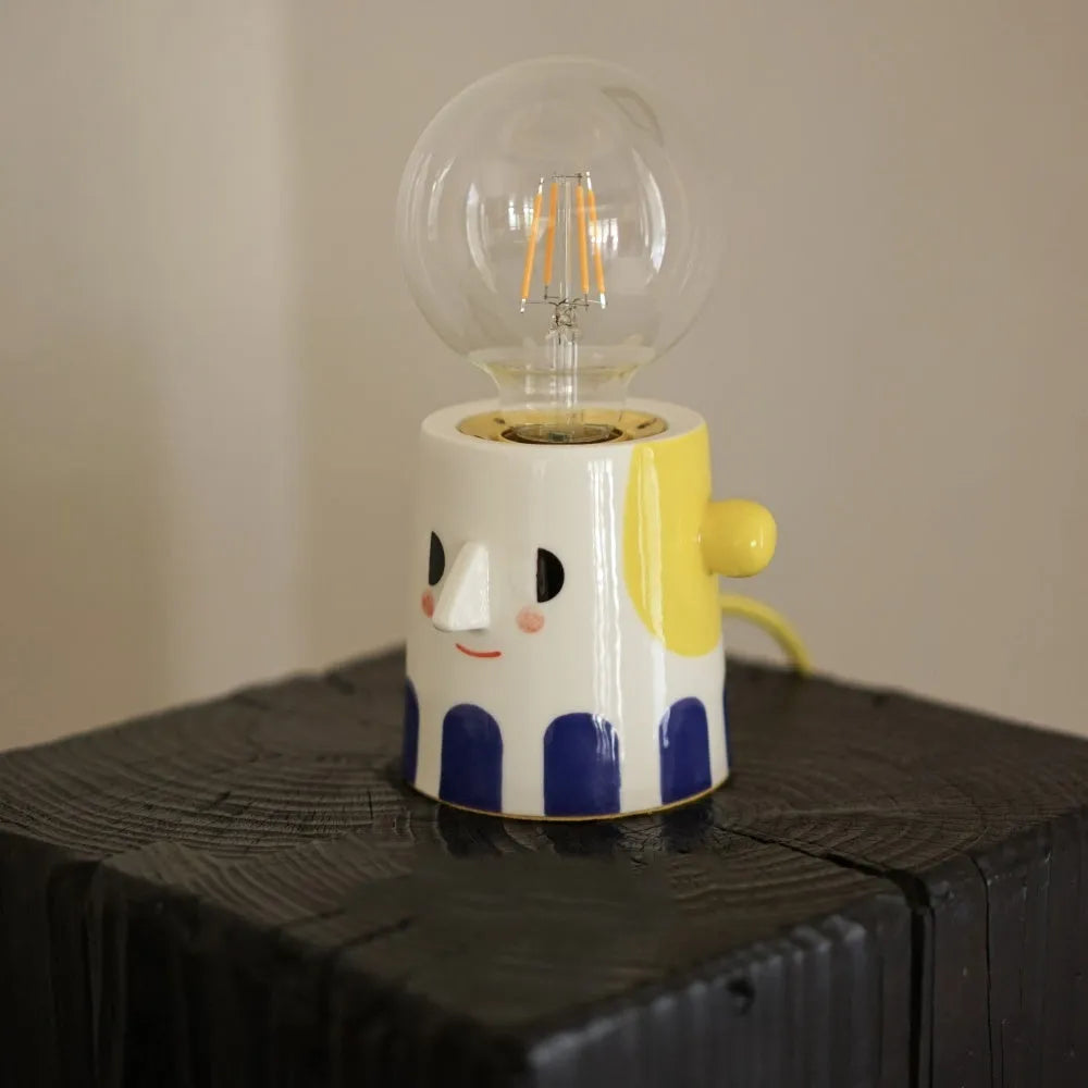 Handmade ceramic bedside lamp with ball headlight colour on wooden table