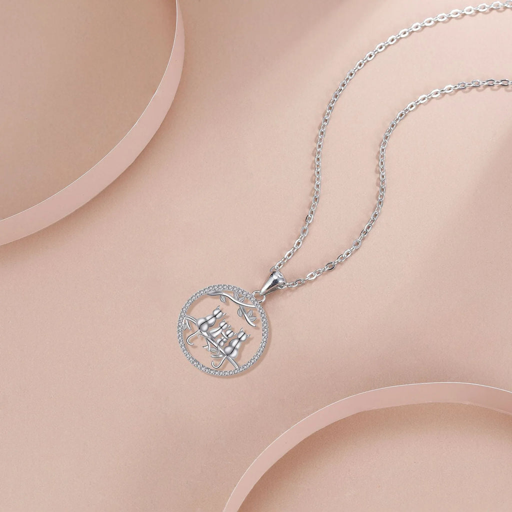 Women's copper necklace with a four kitten pendant on a cross chain, electroplated finish.