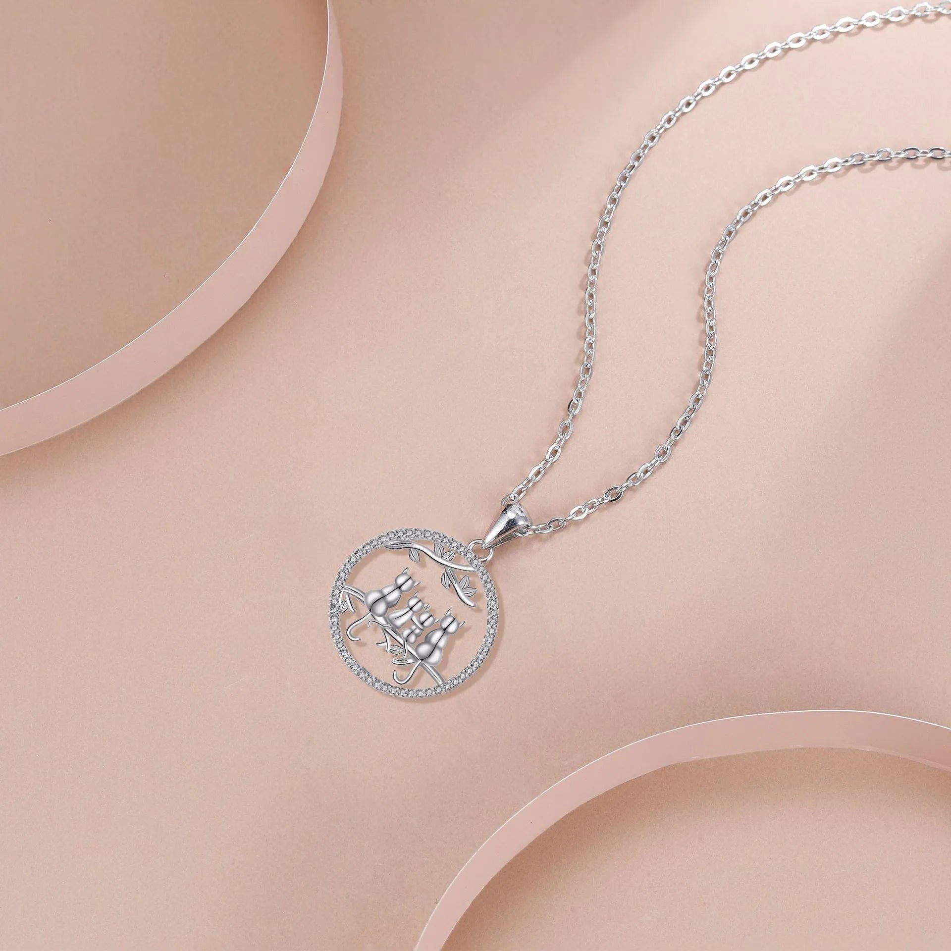 Women's copper necklace with a four kitten pendant on a cross chain, electroplated finish.