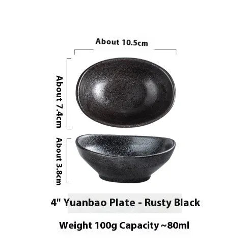 Oval Japanese ceramic sauce dipping bowl with traditional underglaze pattern on a wooden table.