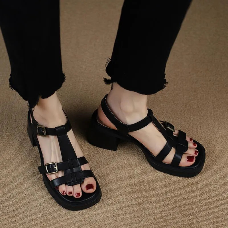 Women's black retro sandals with a T-shaped buckle, open square toe, platform, and chunky heel.