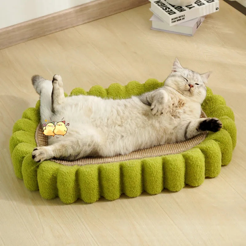 Green oval cat scratching pad with sisal surface measuring 65cm long, functioning as both scratcher and lounger bed
