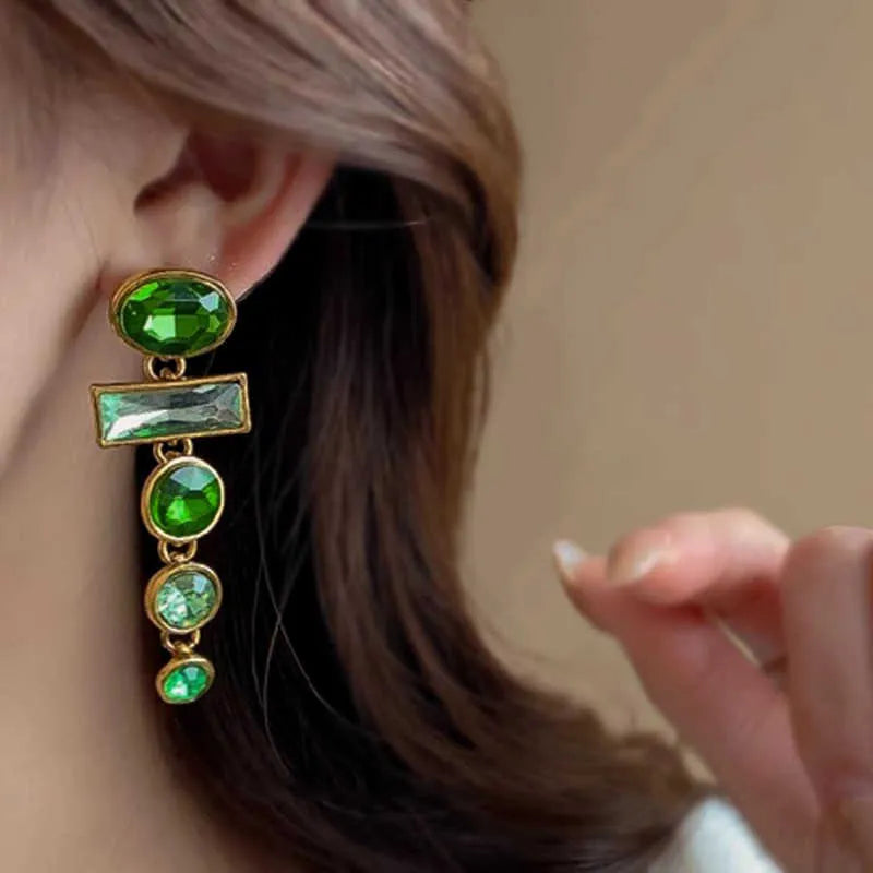 A pair of green gradient tassel earrings with geometric alloy settings and inlaid zircon stones.