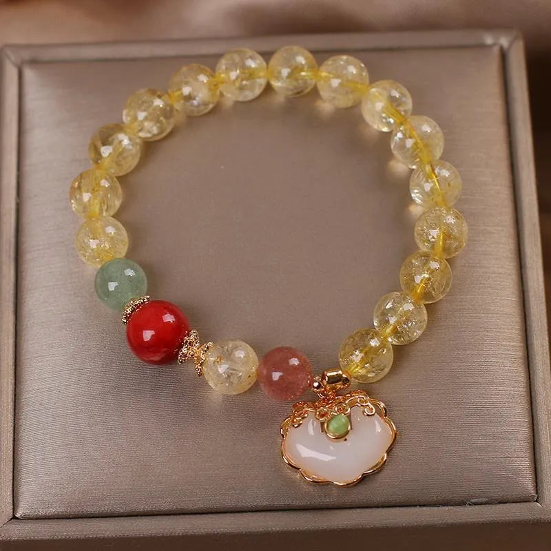 Women's alloy bracelet with a yellow citrine jade ruyi pendant charm.