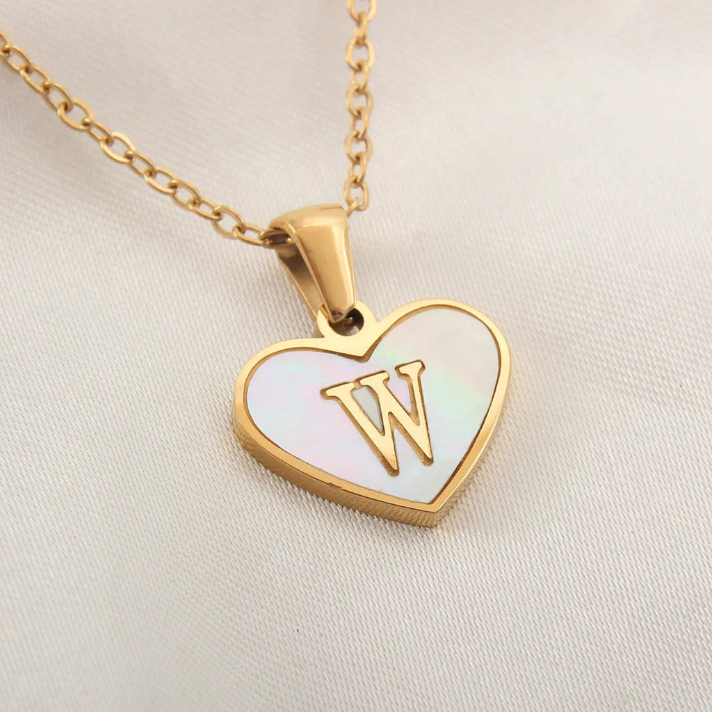 Gold heart necklace with white shell pendant and initial charm on 45cm adjustable chain