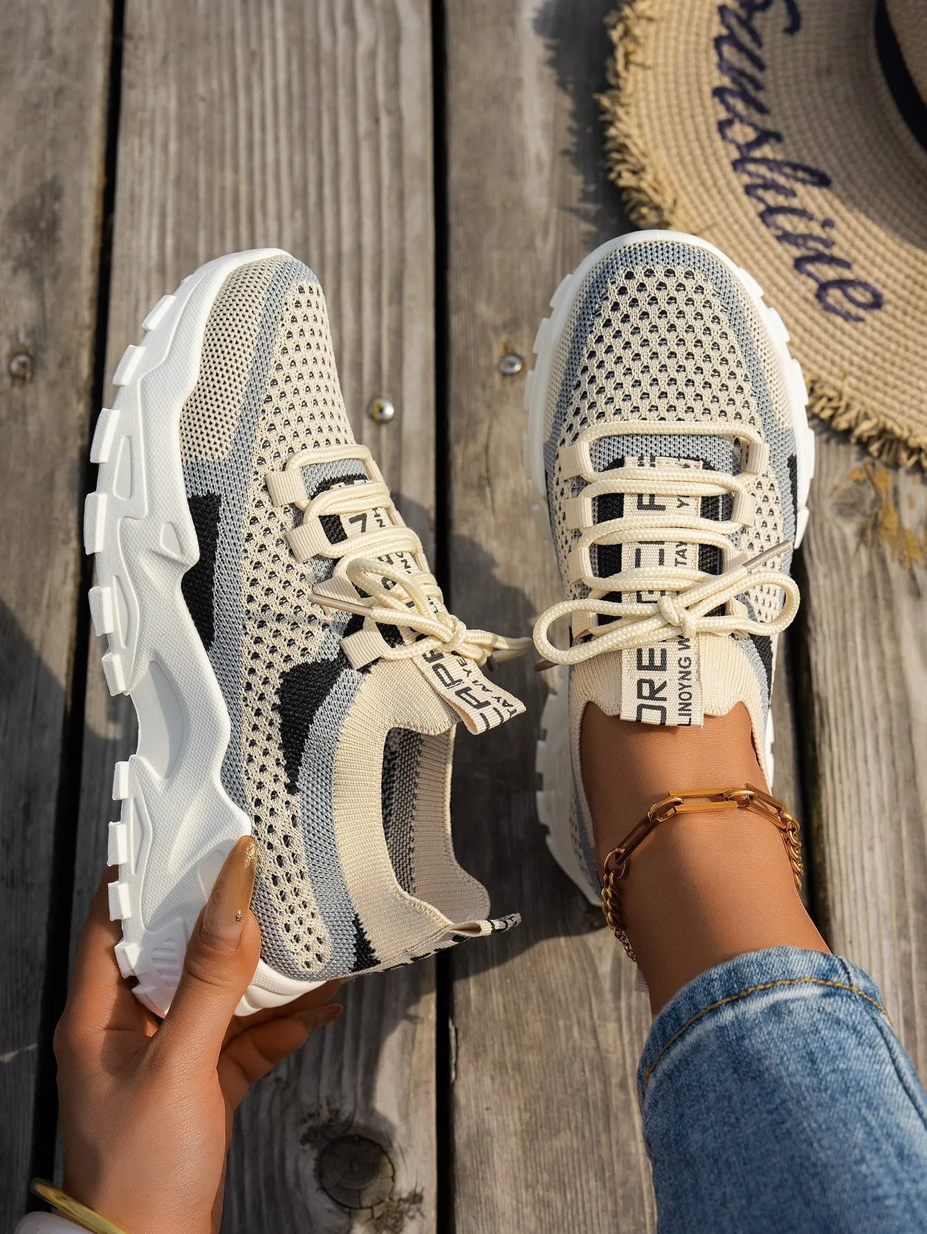 Women's Flyknit mesh lace-up sneakers in a selection of colours, showing round toe and flat rubber sole.