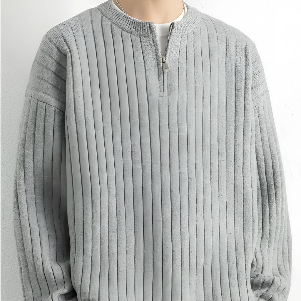 Grey half-zip loose knit sweater for men with long sleeves on a hanger.