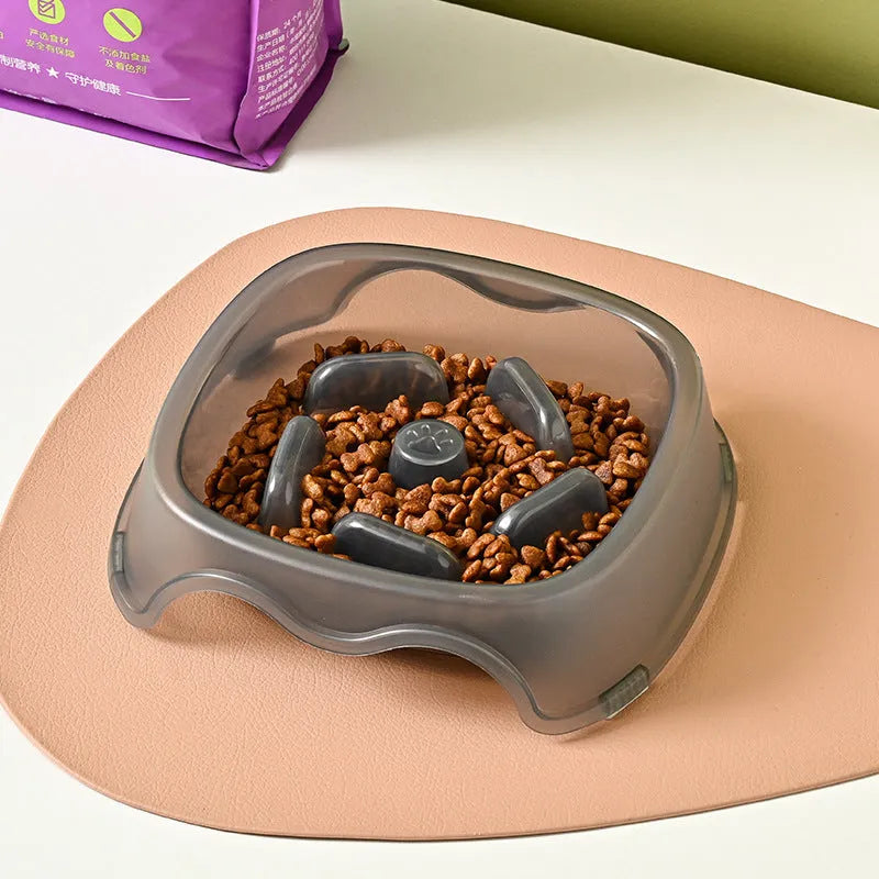 Blue plastic slow feeder dog bowl with anti-choking design on a white surface.