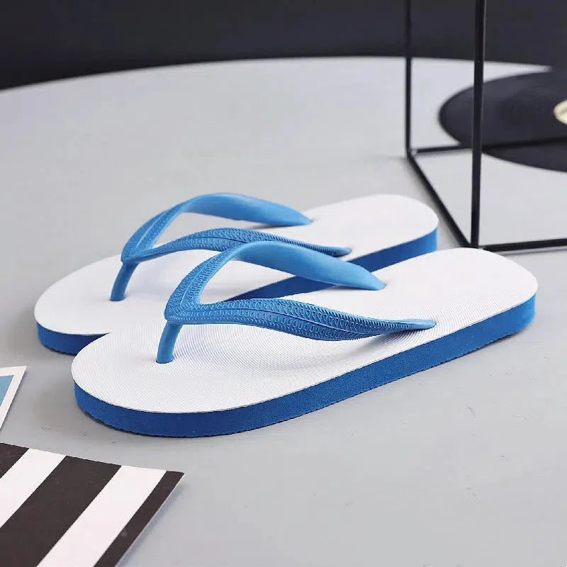 Green rubber flip-flop with fish label design, showing textured non-slip sole.