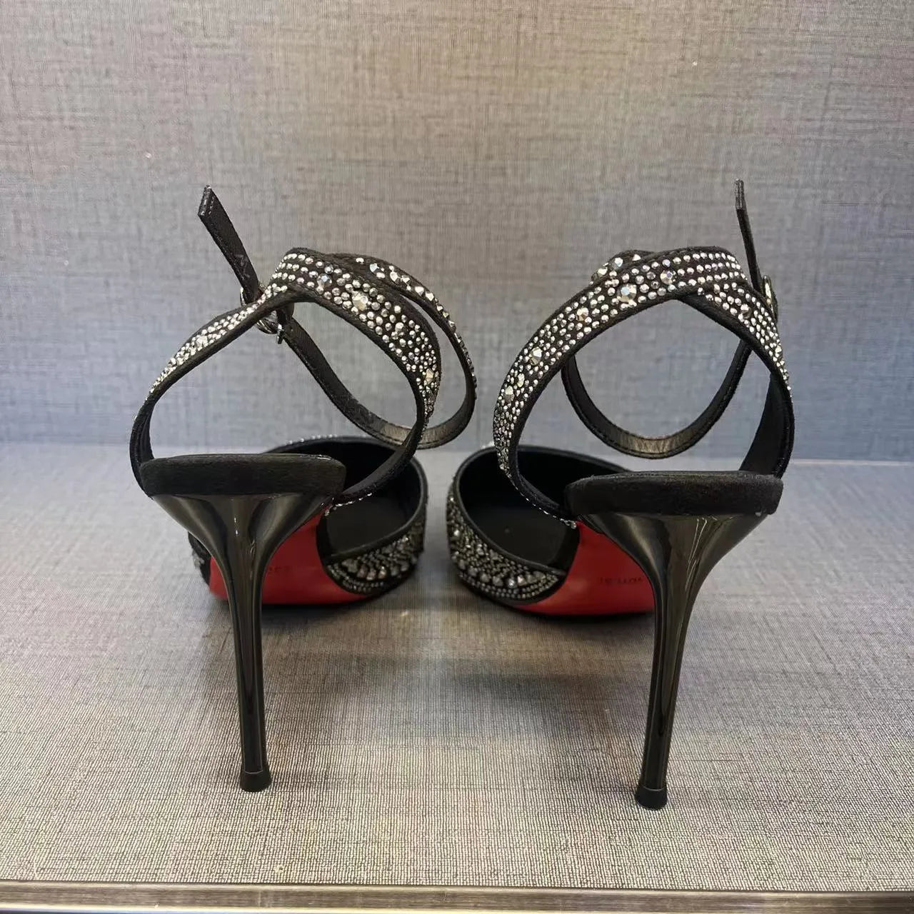 Women's black high heels with hollow stiletto heels and red soles, pointed toe design