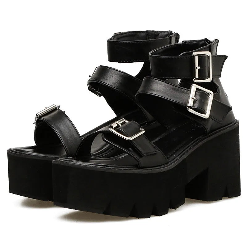 Black women's punk-style sandals with chunky heel, platform sole, buckle, and back zipper.