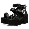 Black women's punk-style sandals with chunky heel, platform sole, buckle, and back zipper.