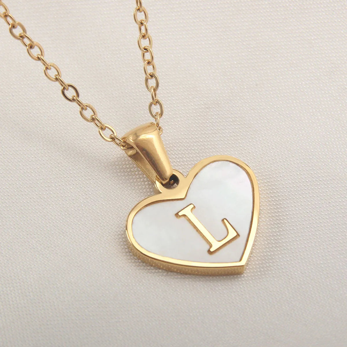 Gold heart necklace with white shell pendant and initial charm on 45cm adjustable chain