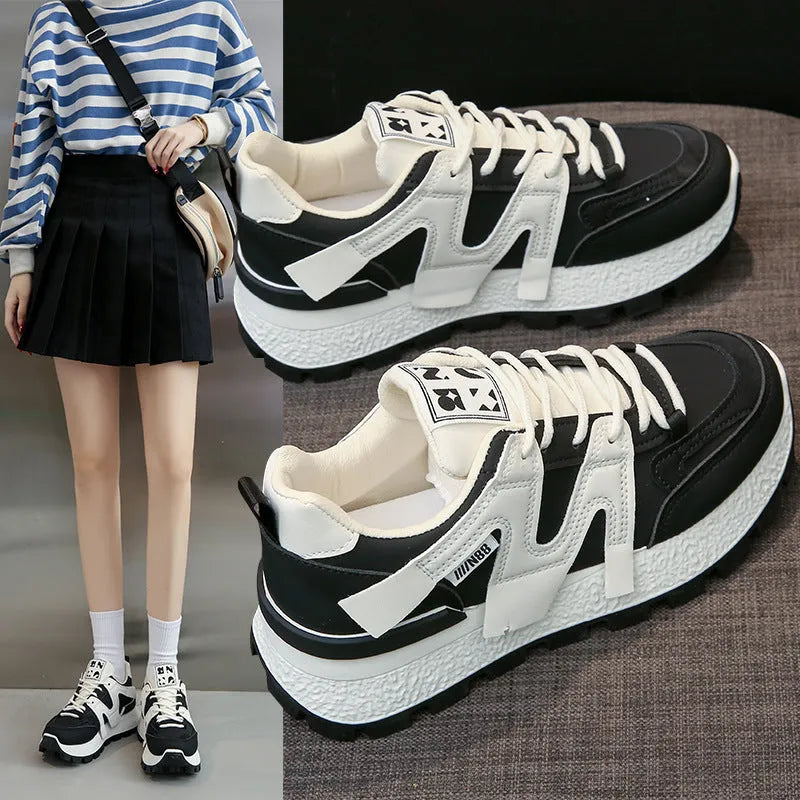 Low-top white and black casual sneakers with round toe and lace-up front