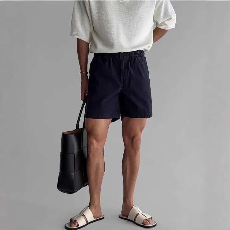 Cotton loose-fit sports shorts in black, shown on a model, suitable for summer activities.