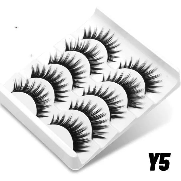 Box of artificial fibre false eyelashes in six styles with a tube of adhesive glue.