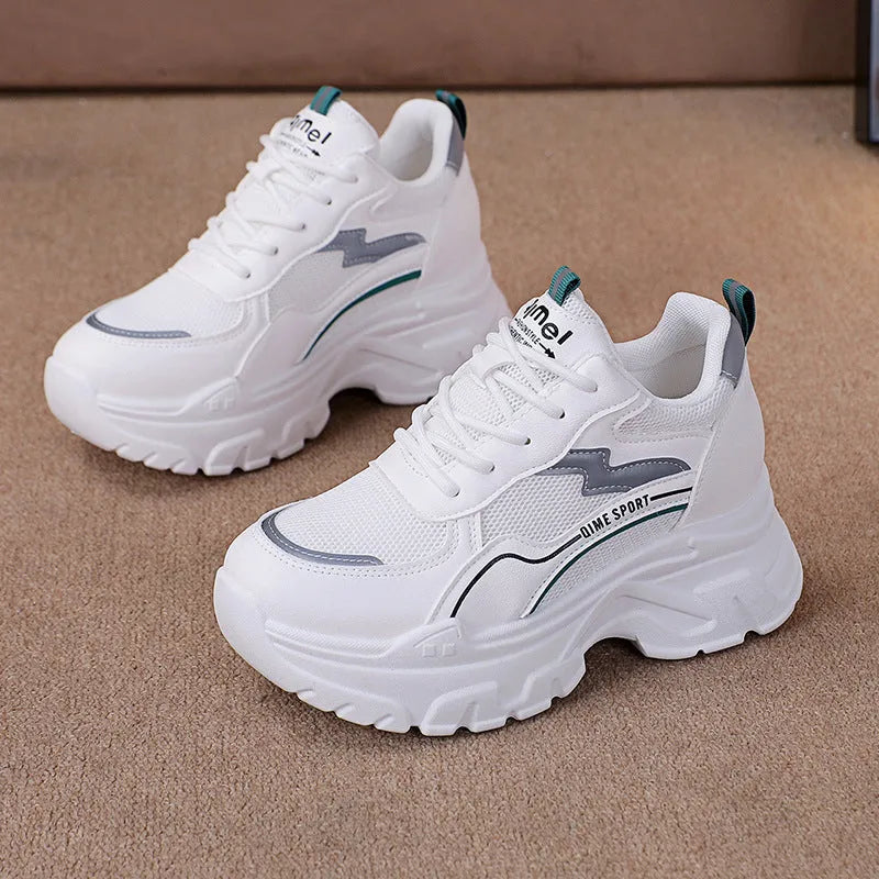 Women's white low-top dad shoes with cross straps and lace-up front