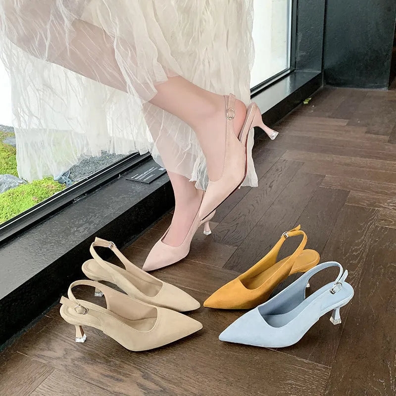 A pair of apricot suede pointed toe stiletto high heels with a rubber sole.