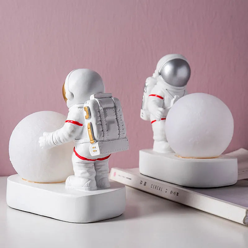 Gold resin astronaut night light on shelf, 14.5cm tall figurine with soft glow