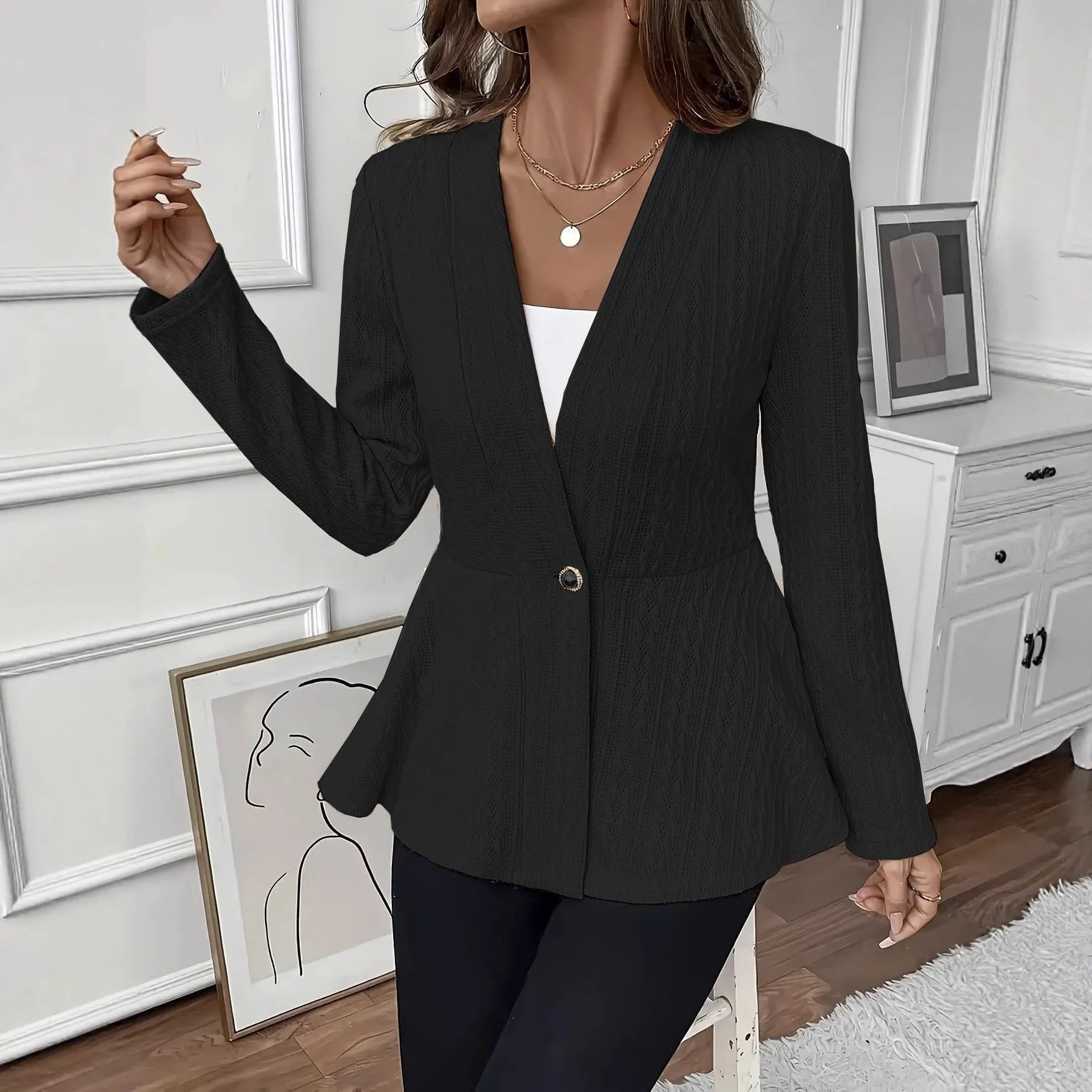 Women's apricot coloured Jacquard patterned knitted cardigan with one button, shown on a model.