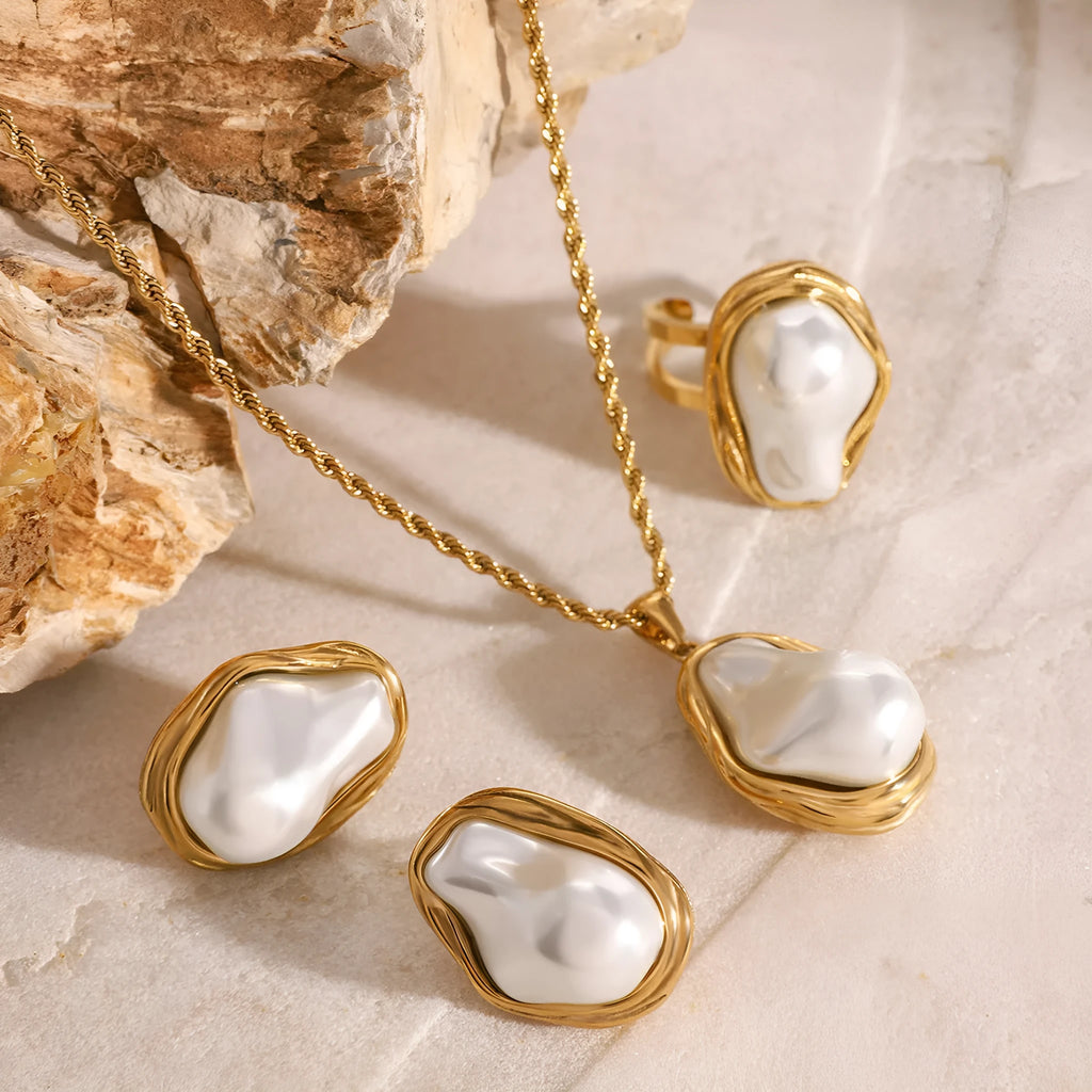 Women's stainless steel necklace with irregular mother pearl shellfish pendant on regular chain, with matching earrings and ring