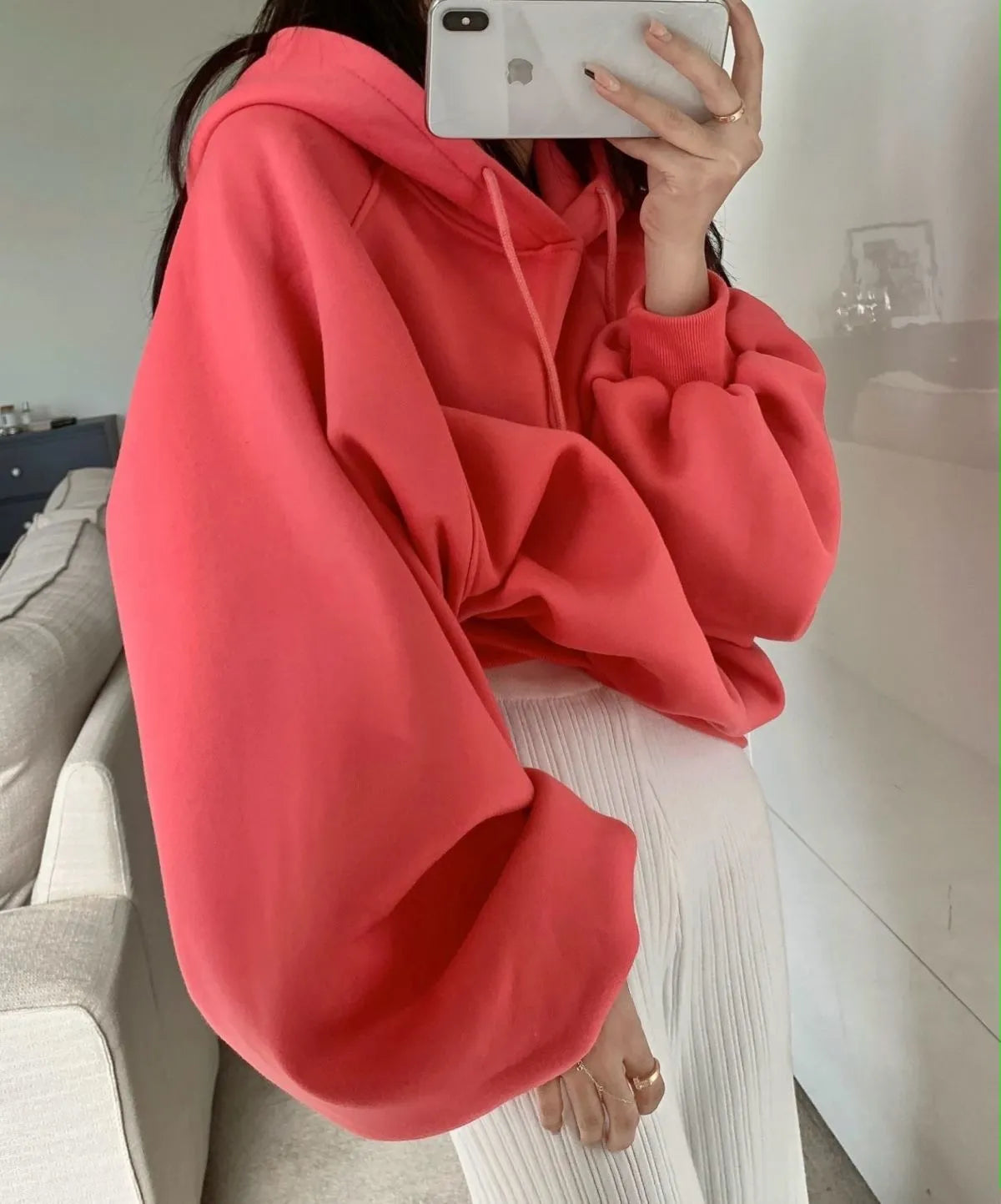 Women's watermelon red Mulberry Silk hooded sweater on a hanger, showing loose fit and front design.