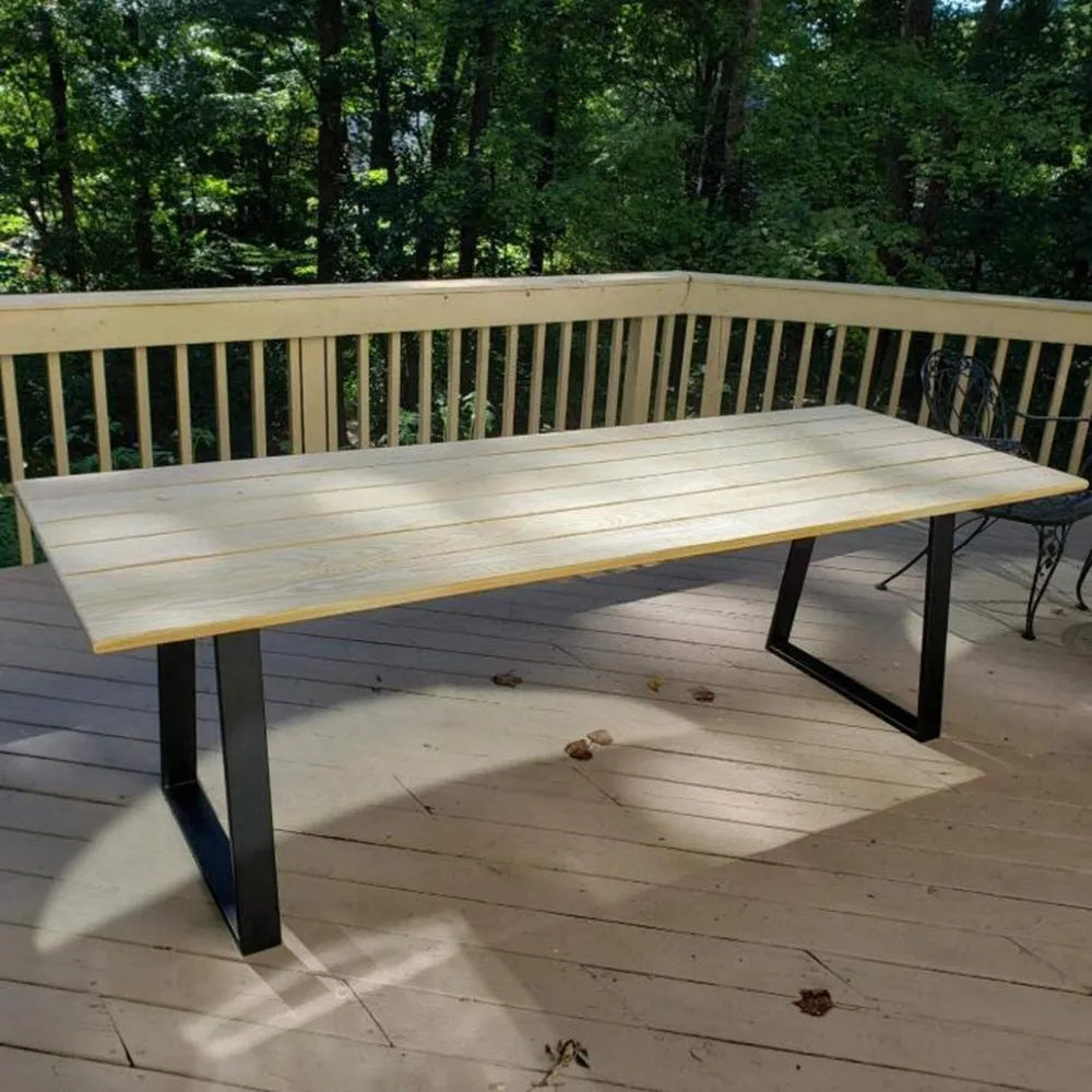 Wrought iron table legs in matte black finish with screws and foot pads on floor