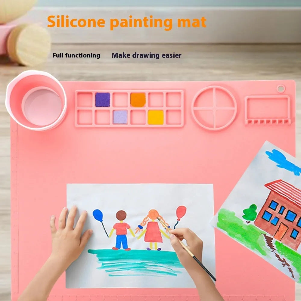 Light blue silicone painting mat with two integrated bowls for paint mixing, measuring 50cm by 40cm.