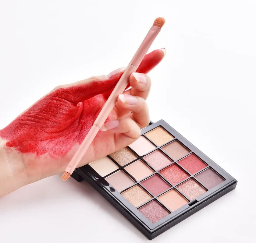 Open case showing 10 pink-handled makeup brushes including loose powder, foundation, flat head, and double-ended brushes.
