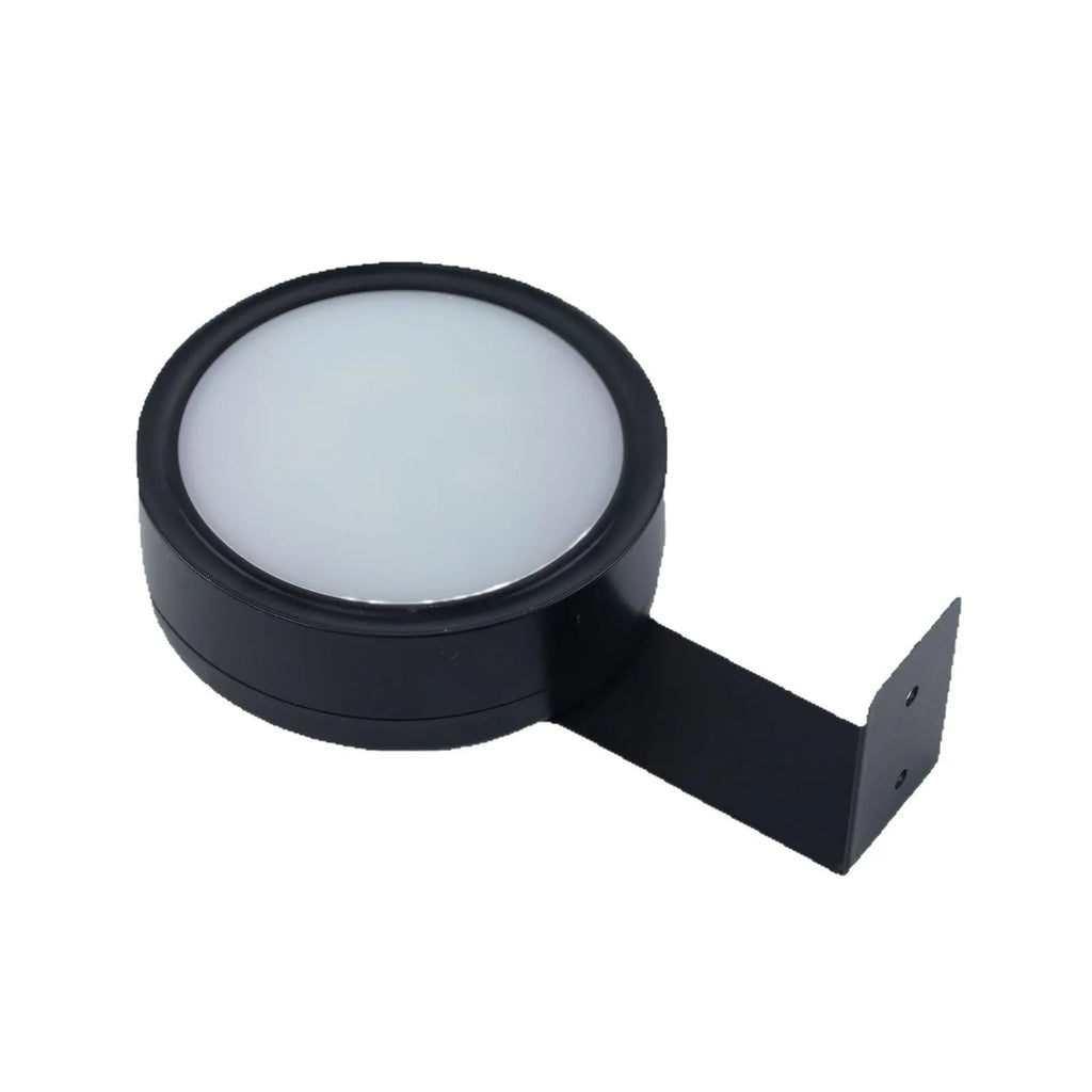 Wireless magnetic LED picture light with remote control in black, mounted on a painting frame.