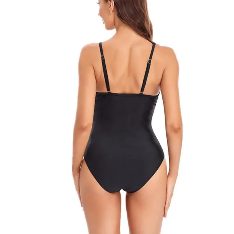 Ladies black mesh one-piece swimsuit with backless design on mannequin
