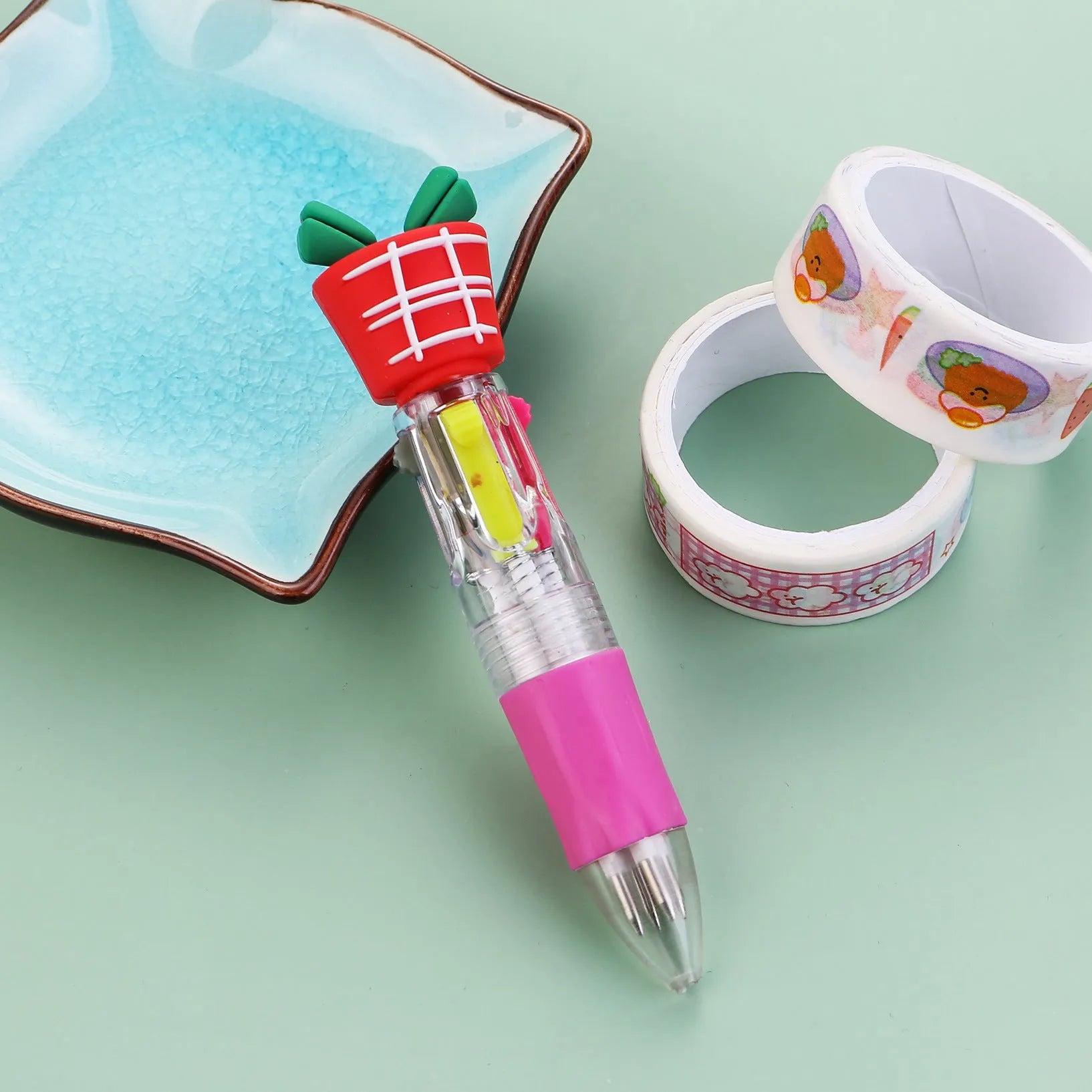 Christmas mini four-colour press-type ballpoint pen showing festive designs, 11cm long.